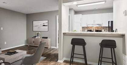 Model apartment living room with a breakfast bar and a kitchen