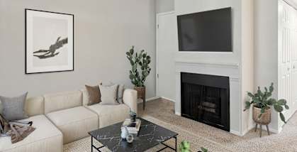 Model Living Room with Carpet and Fireplace at Broadmoor Village Apartments located in West Jordan, UT-HERO.
