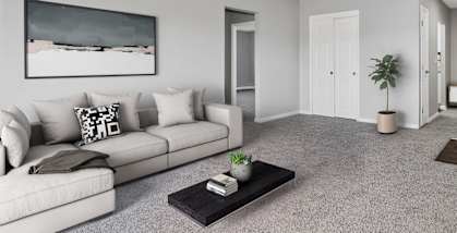 Model Living Room with Carpet at Stone Ends Apartments located in Stoughton, MA-HERO.