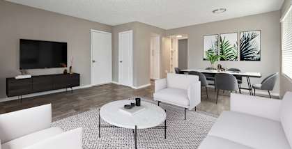 Model Living Room with Wood-Style Flooring at Bridges at 9 Mile Station Apartments in Denver, CO-HERO.