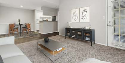 Model Living Room with Carpet and Patio Accessibility at Walden Lake Apartments in Plant City, FL-HERO.