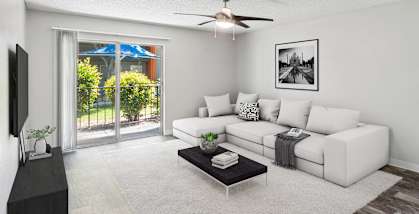Model Living Room with Wood-Style Flooring and Patio Accessibility at Indigo Park Apartments located in Albuquerque, NM-HERO.