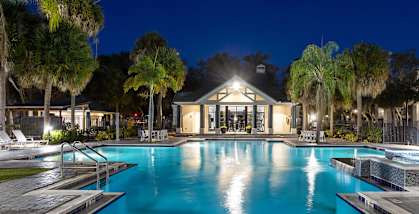 Community Swimming Pool with Pool Furniture at Caribbean Breeze Apartments in Tampa, FL