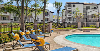 Community Swimming Pool with Pool Furniture at Reserve at Rancho Apartments located in Moreno Valley, CA-HERO.