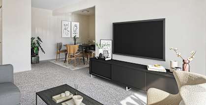 Model Living Room with Carpet and View of Dining Room at Spring Parc Apartments in Silver Spring, MD-HERO.