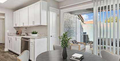 Model Living Room and Kitchen with Patio Accessibility at Peaks on 4th Apartments located in Avondale, AZ-HERO.