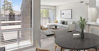 an open kitchen and living room with a dining room table