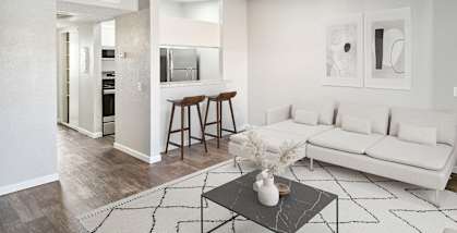 Model apartment living room with a white couch and a coffee table