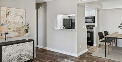 Model apartment living room and dining room with a table and chairs