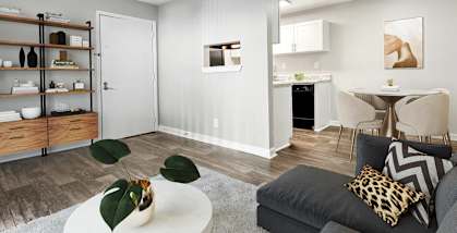 Model apartment living room with a couch and a table