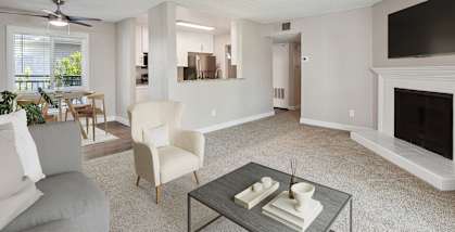 Model apartment living room with a fireplace and a couch