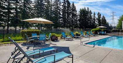 Community Swimming Pool with Pool Furniture at Landings at Morrison Apartments located in Gresham, OR-HERO.