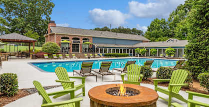 Outdoor firepit with chairs and a pool