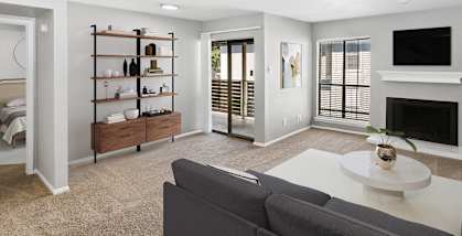 Model Living Room with Carpet, Fireplace and Patio Accessibility at Summit Ridge Apartments located in Arlington, TX-HERO.