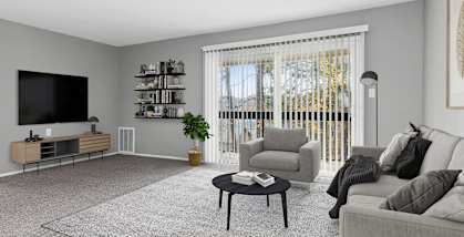 Model apartment living room with a couch and a coffee table