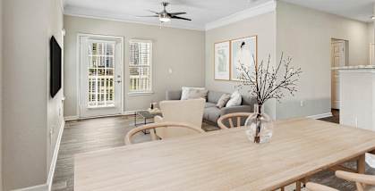 a living room and dining room with a wooden table