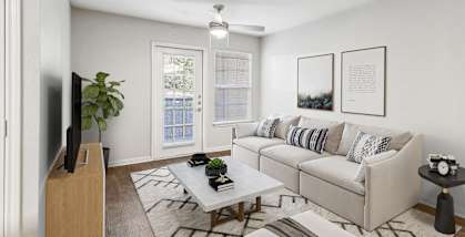 Model Living Room with Wood-Style Flooring and Patio Accessibility at Lake Cameron Apartments located in Apex, NC-HERO.