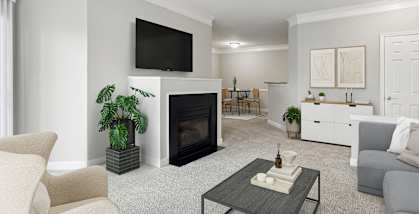 Model Living Room with Carpet, Fireplace and Patio Accessibility at Dulles Green Apartments located in Herndon, VA-HERO.