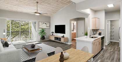 Model Dining Room and Kitchen Area with View of Living Room at Essence Apartments in Dallas, TX