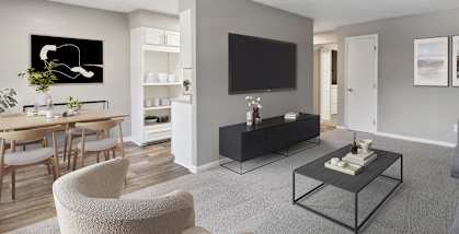 Model Living Room with Carpet and View of Kitchen/Dining Area at Spring Forest Apartments in Raleigh, NC-HERO.