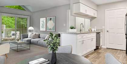Model Dining Room and Kitchen with Wood-Style Flooring and White Cabinets at Park 2300 Apartments in Charlotte, NC-HERO.