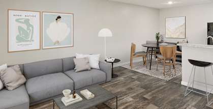 Model Living Room with Wood-Style Flooring and View of Kitchen at San Mateo Apartments in Tucson, AZ-HERO.