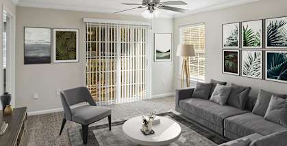 Model Living Room with Carpet and Patio Accessibility at Shadow Ridge Apartments in Riverdale, GA-HERO.