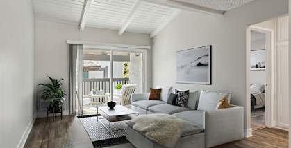 Model Living Room with Wood-Style Flooring and Patio Accessibility at Colonnade at Fletcher Hills Apartments in El Cajon, CA-HERO.