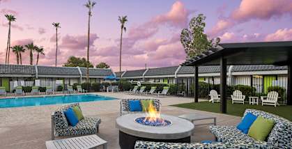 Outdoor Fire Pit Area and Swimming Pool with Lounge Furniture at Arcadia on 49th Apartments located in Phoenix, AZ-HERO.