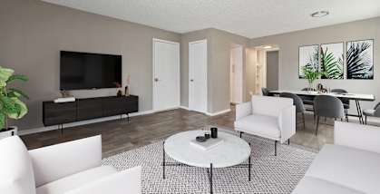 Model Living Room with Wood-Style Flooring at Bridges at 9 Mile Station Apartments in Denver, CO-HERO.