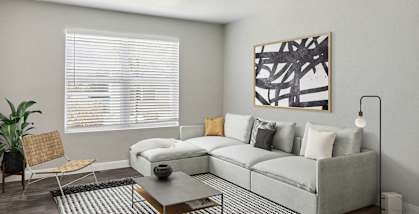 Model Living Room with Wood-Style Flooring at Monterra Apartments located in Las Vegas, NV-HERO.