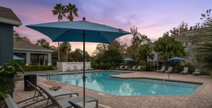 Community Swimming Pool with Pool Furniture at Westland Park Apartments in Jacksonville, FL-HERO.