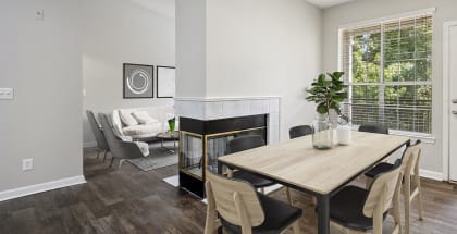 Model apartment dining room with a table and chairs and a fireplace
