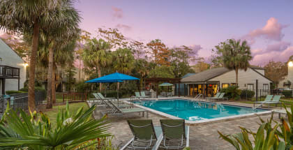 Community Swimming Pool with Pool Furniture at Heron Walk Apartments in Jacksonville, FL-HERO.