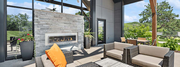 Clubhouse outdoor lounge area and a fireplace and chairs at Elevate on Parkway, Minnesota, 55337