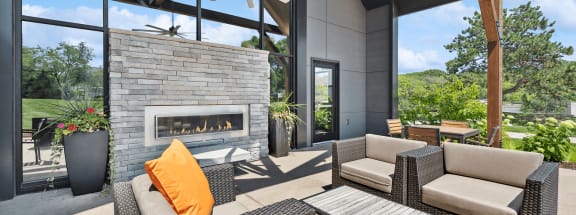 Clubhouse outdoor lounge area and a fireplace and chairs at Elevate on Parkway, Minnesota, 55337