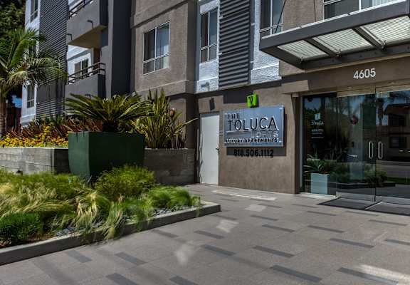 A building with a green sign at Toluca Lofts, California