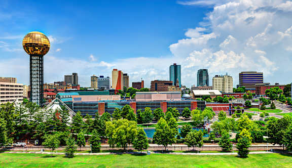 A cityscape with a prominent tower in the center.