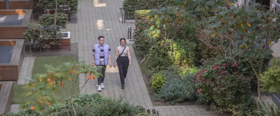 a man and a woman walking down a sidewalk