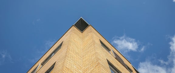 the top of a brick building against a blue sky