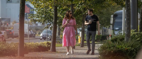 a man and a woman walking down a sidewalk