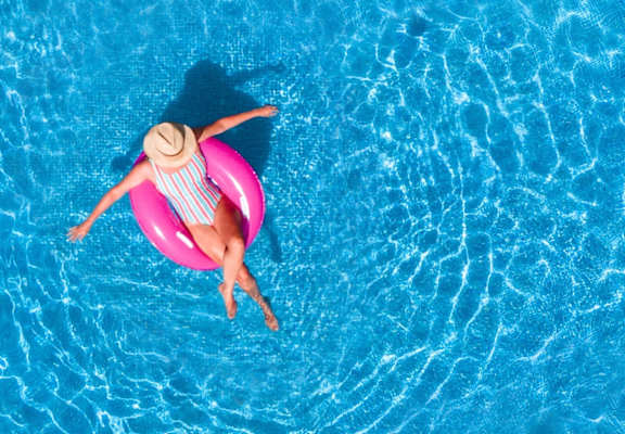 Woman Wearing Hat Relaxing in Pool