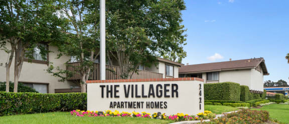 a view of the village apartments sign
