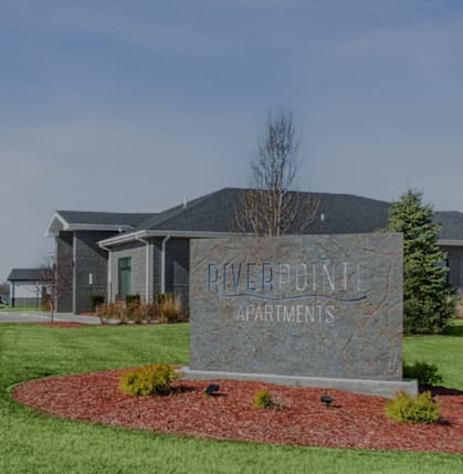A sign in front of a building that says "Powerline Apartments".