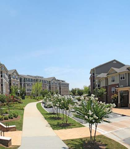 a view of an apartment complex with walkways and landscaping