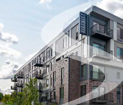 a rendering of an apartment building with balconies and a sky background
