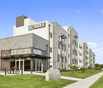 a large building with a lawn in front of it