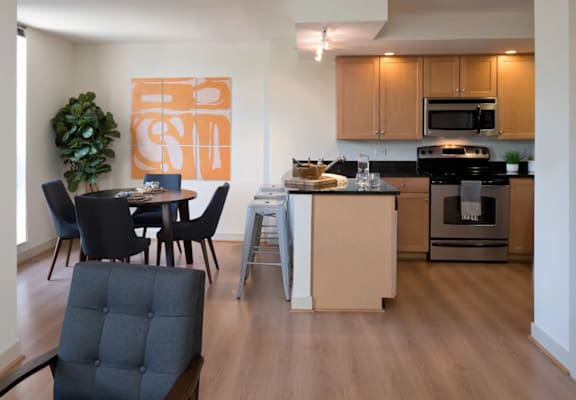A kitchen with a dining table and chairs.