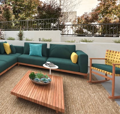 a patio with a green couch and yellow and blue pillows