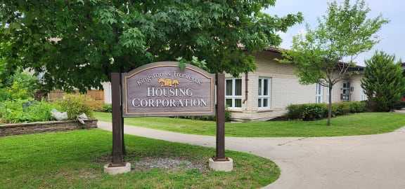 a sign for housing corporation in front of a building